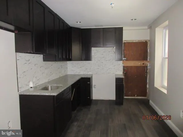 a kitchen with a sink and refrigerator
