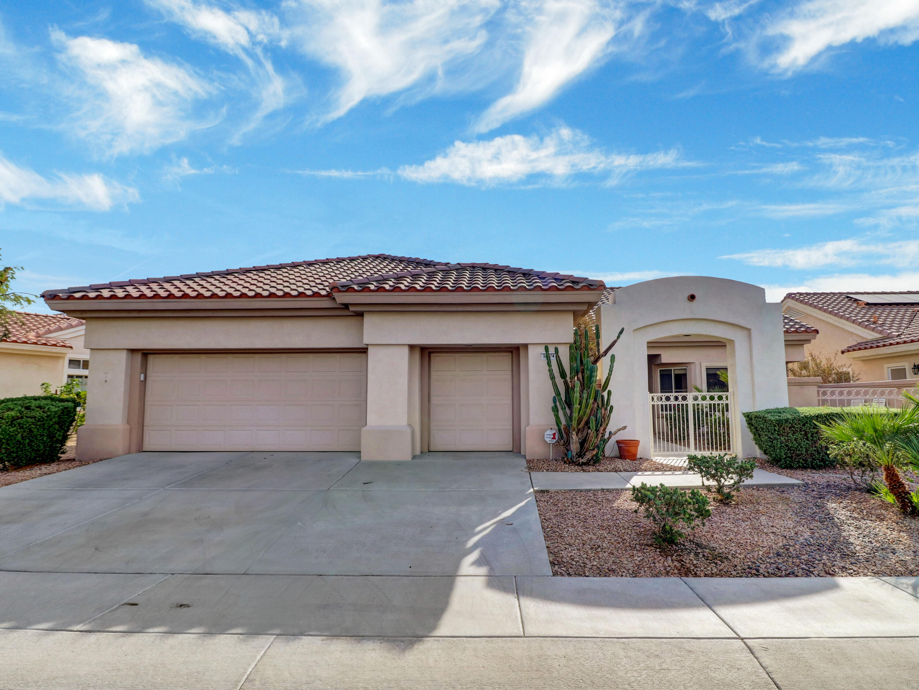 38574 Clear Sky Way Palm Desert, CA 92211 - Photo 1 of 69 a front view of a house with garden