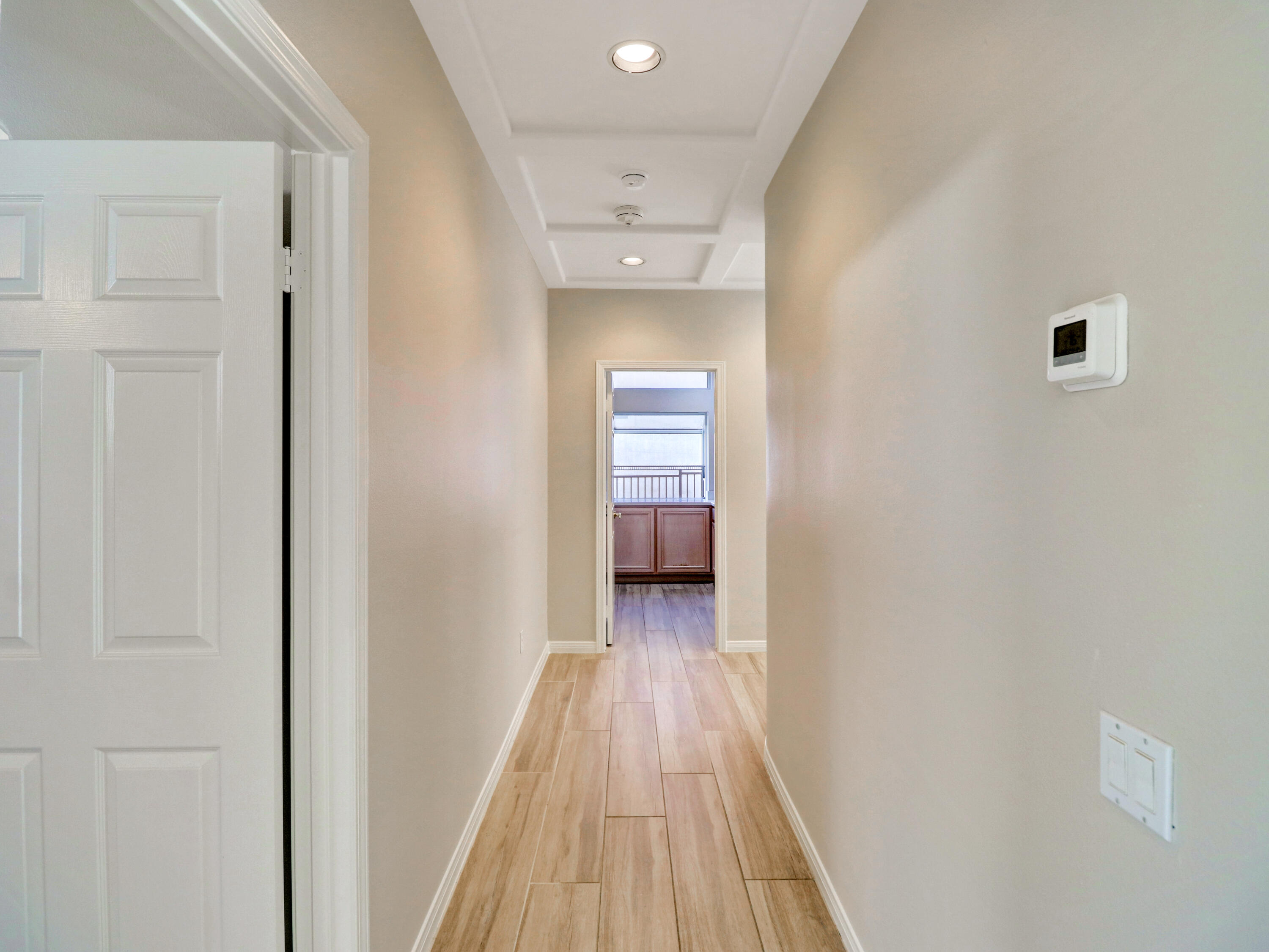 38574 Clear Sky Way Palm Desert, CA 92211 - Photo 11 of 69 a view of a hallway with wooden floor