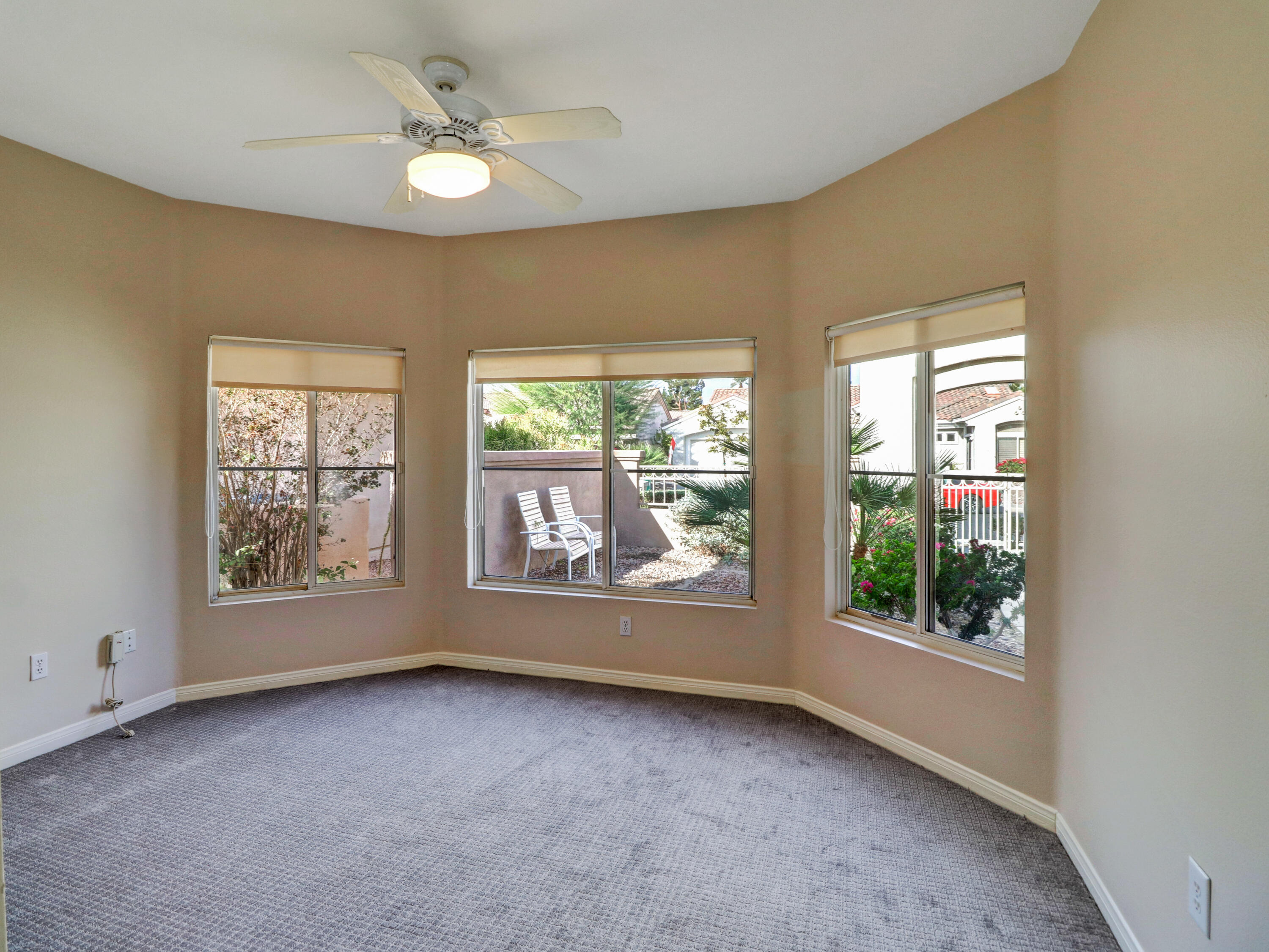 38574 Clear Sky Way Palm Desert, CA 92211 - Photo 12 of 69 an empty room with windows and ceiling fan