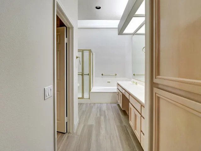 a kitchen with stainless steel appliances granite countertop a stove a sink and dishwasher with wooden floor