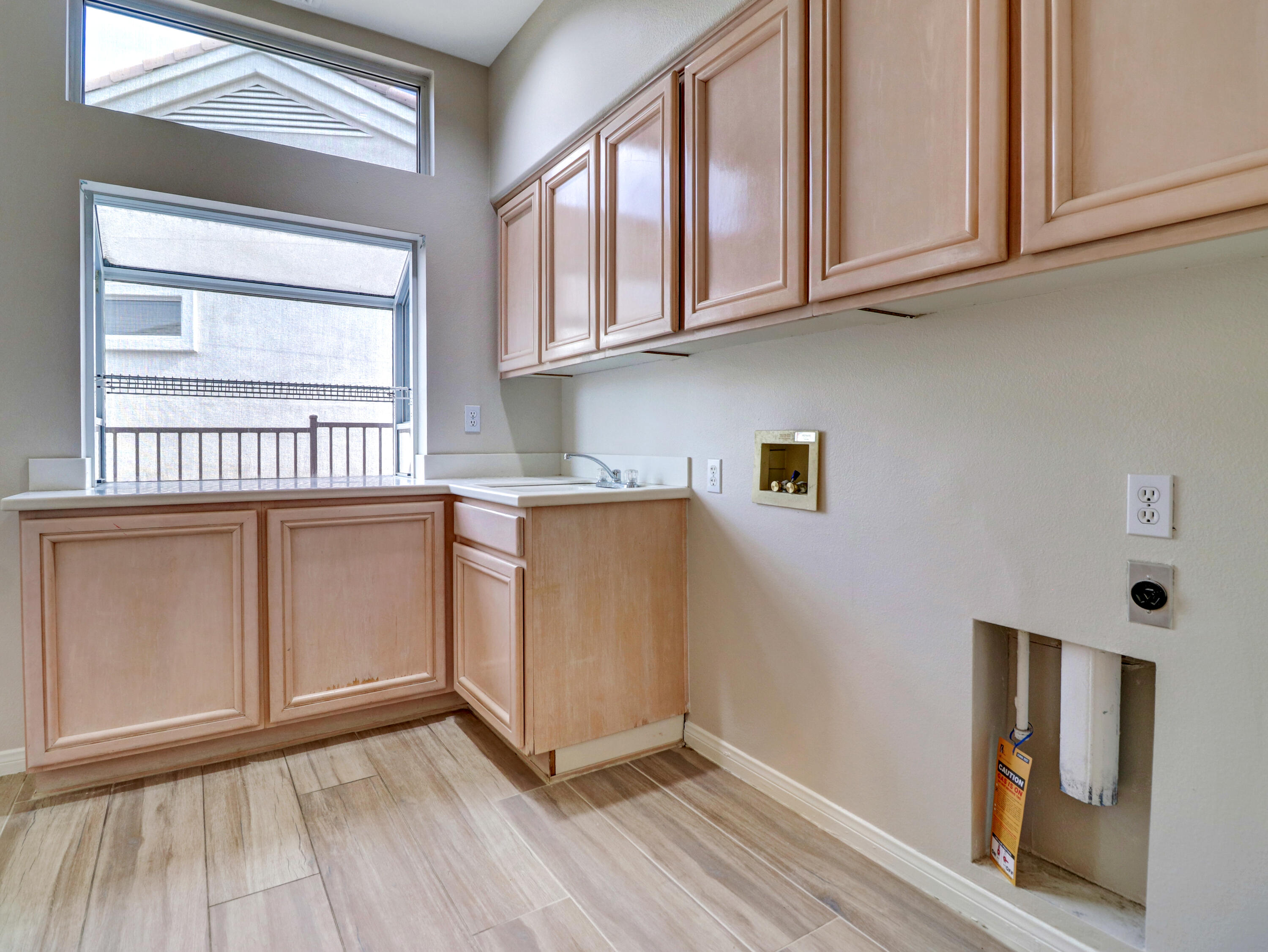 38574 Clear Sky Way Palm Desert, CA 92211 - Photo 27 of 69 a kitchen with stainless steel appliances granite countertop a stove a sink and dishwasher with wooden floor