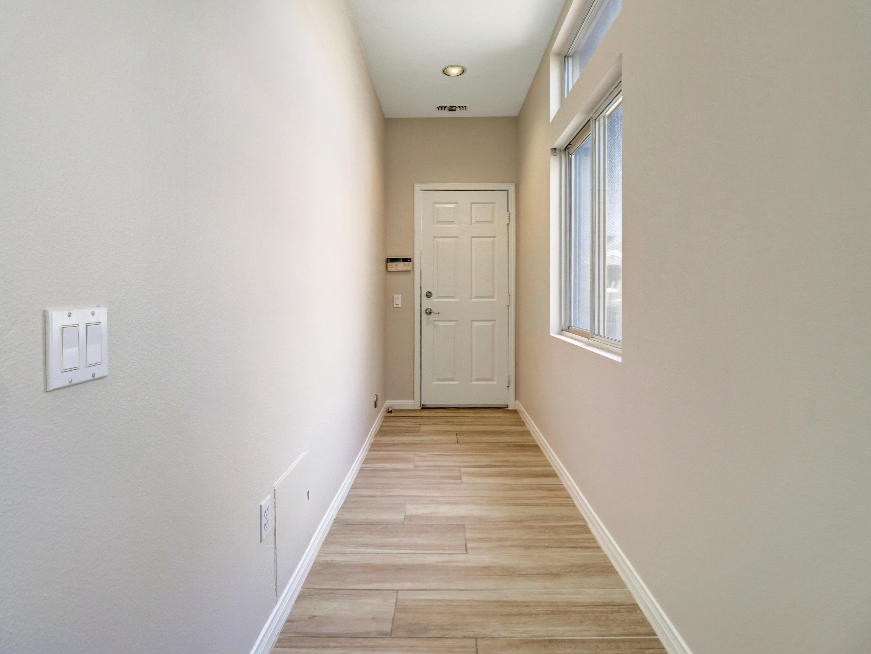 38574 Clear Sky Way Palm Desert, CA 92211 - Photo 28 of 69 a view of a hallway with wooden floor and a bathroom