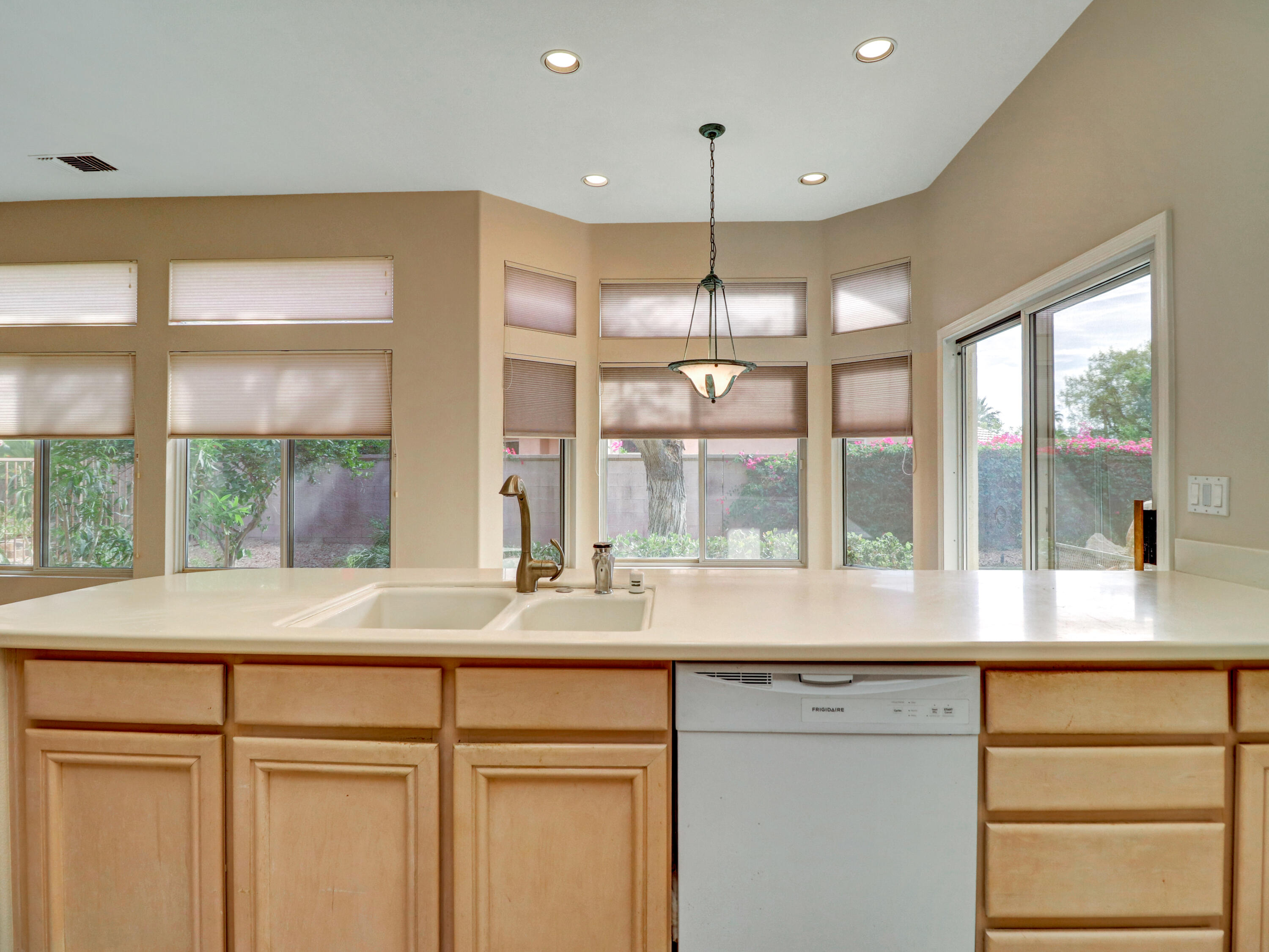 38574 Clear Sky Way Palm Desert, CA 92211 - Photo 38 of 69 a kitchen with kitchen island a large window in it