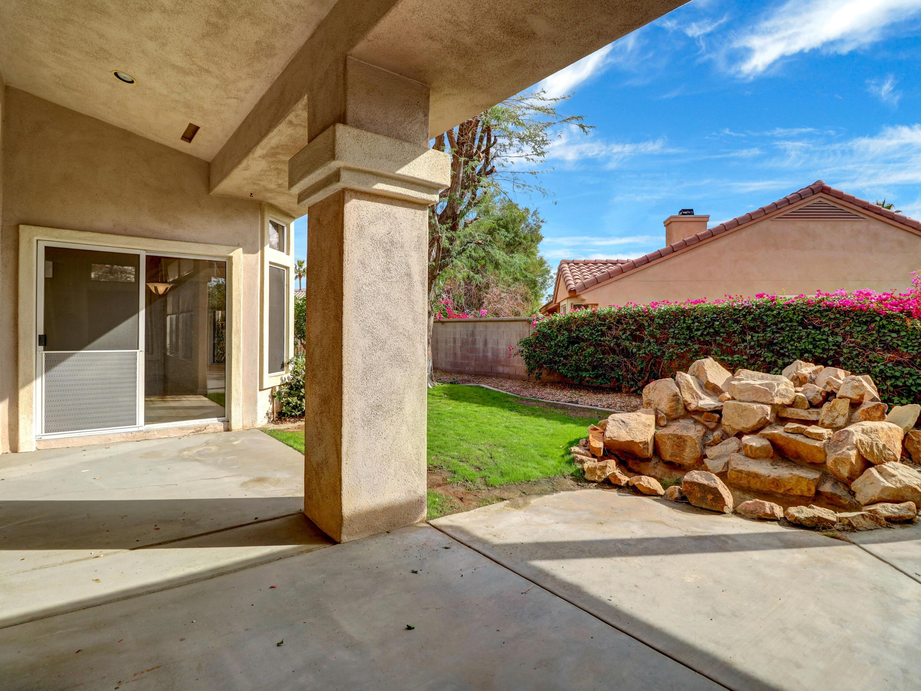 38574 Clear Sky Way Palm Desert, CA 92211 - Photo 40 of 69 a view of a porch with couches and table and chairs next to yard