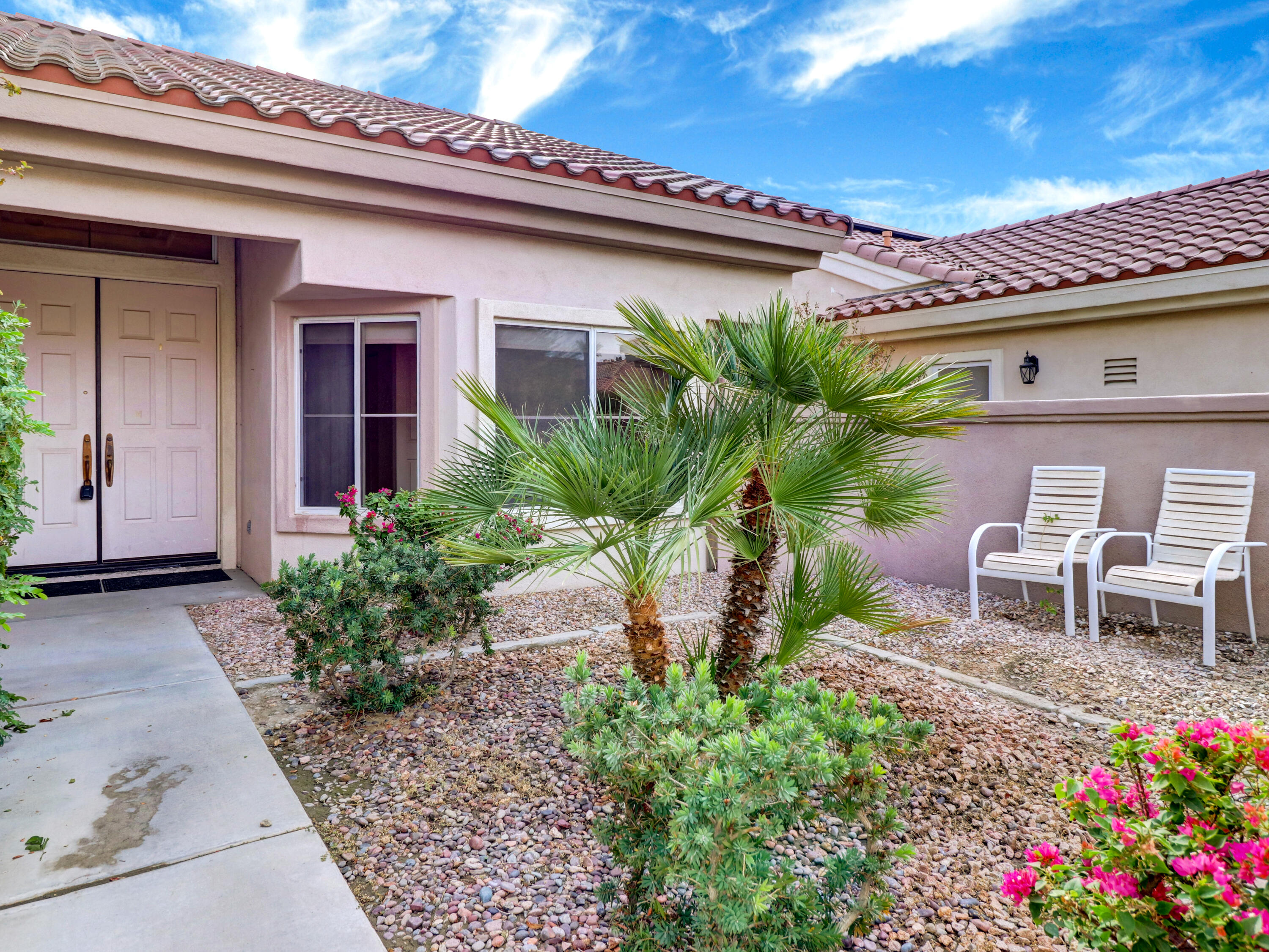 38574 Clear Sky Way Palm Desert, CA 92211 - Photo 4 of 69 a view of a patio with table and chairs and potted plants