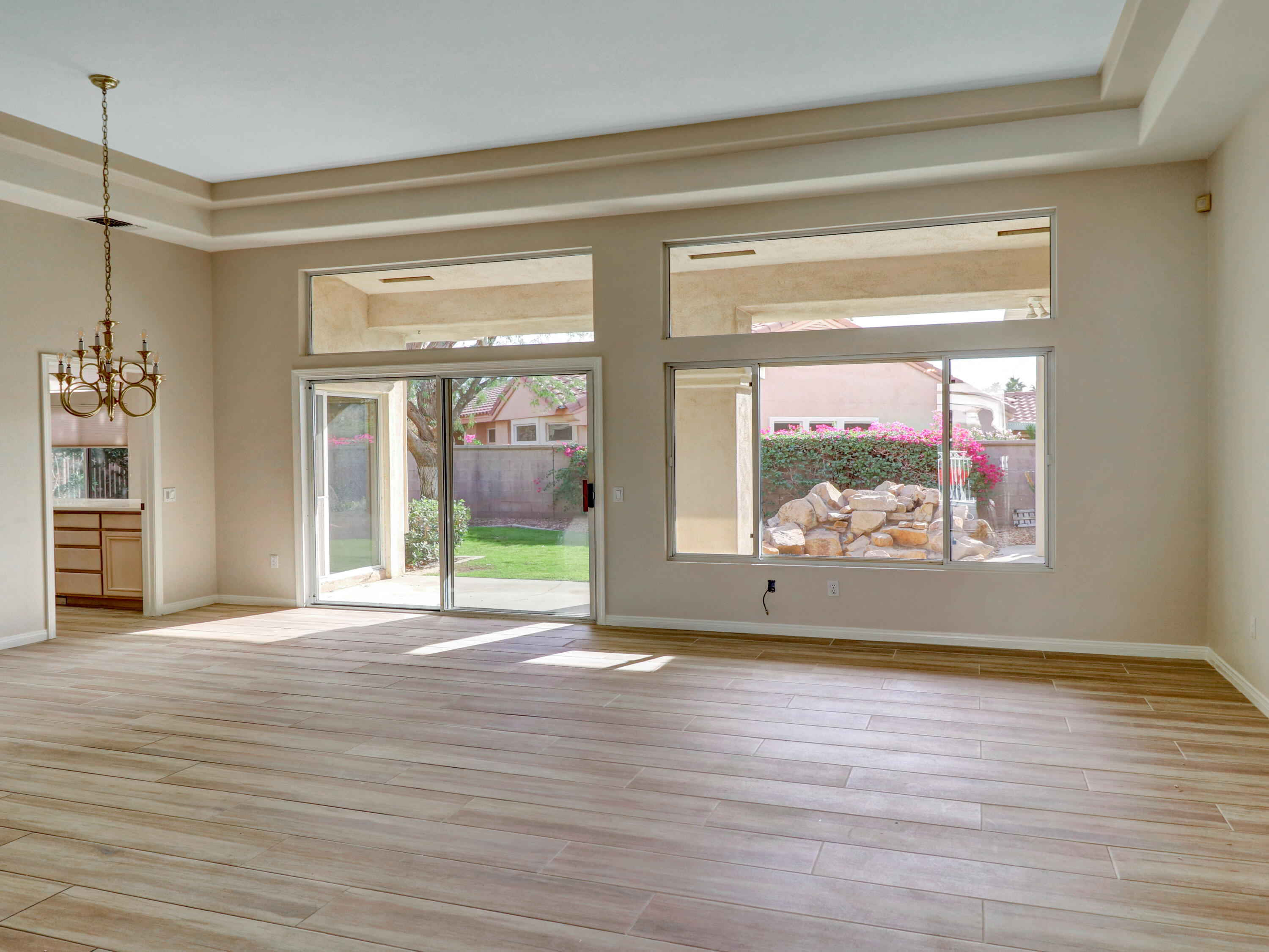 38574 Clear Sky Way Palm Desert, CA 92211 - Photo 6 of 69 a view of an empty room with wooden floor and a window