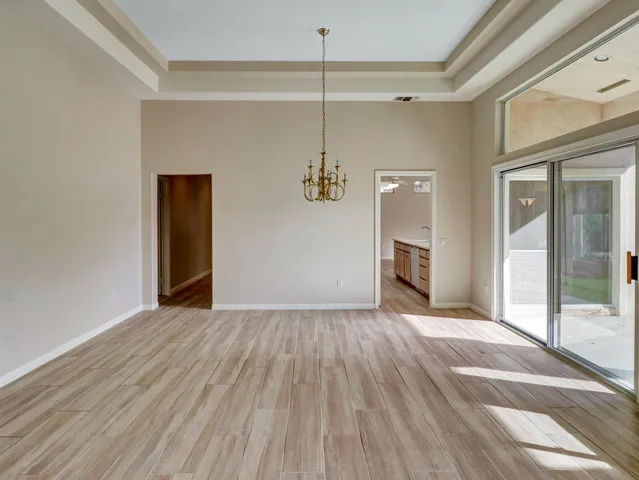 a view of a livingroom with wooden floor and a ceiling fan