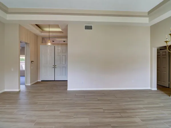 a view of an empty room and wooden floor