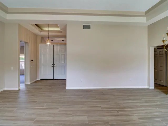 a view of an empty room and wooden floor