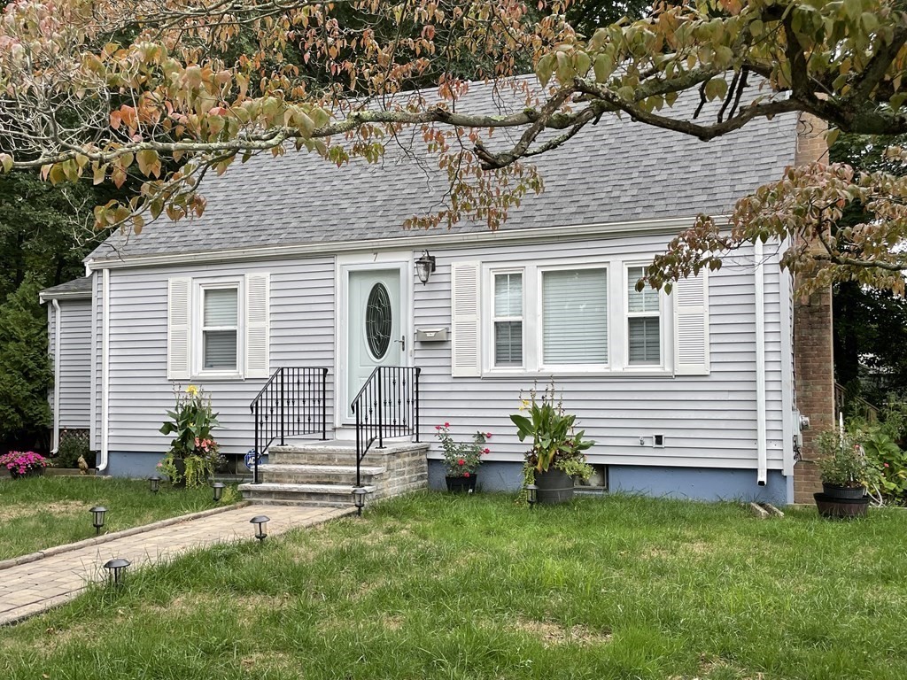 a front view of a house with a garden