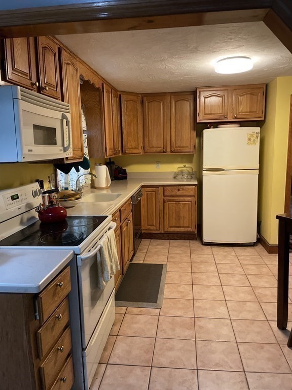 7 Marconi Drive Randolph, MA 02368 - Photo 15 of 24 a kitchen with a sink appliances and cabinets