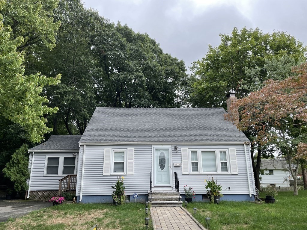 7 Marconi Drive Randolph, MA 02368 - Photo 2 of 24 a view of a yard in front of a house with plants and large tree