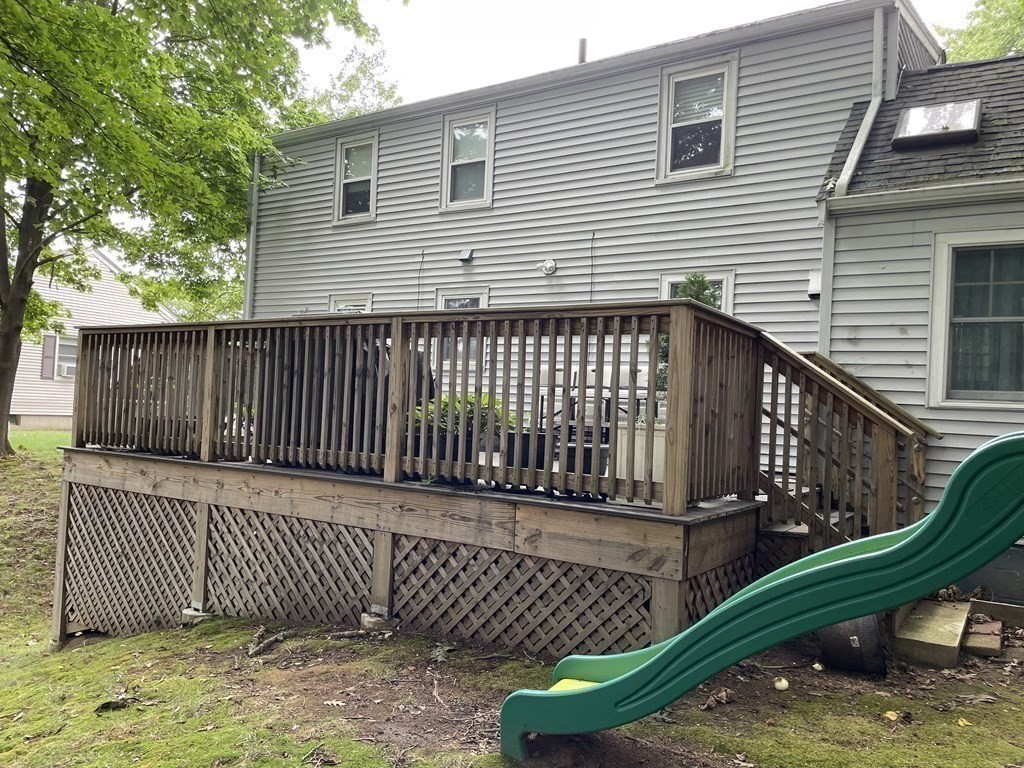 7 Marconi Drive Randolph, MA 02368 - Photo 22 of 24 a view of a brick house with a small yard and wooden fence