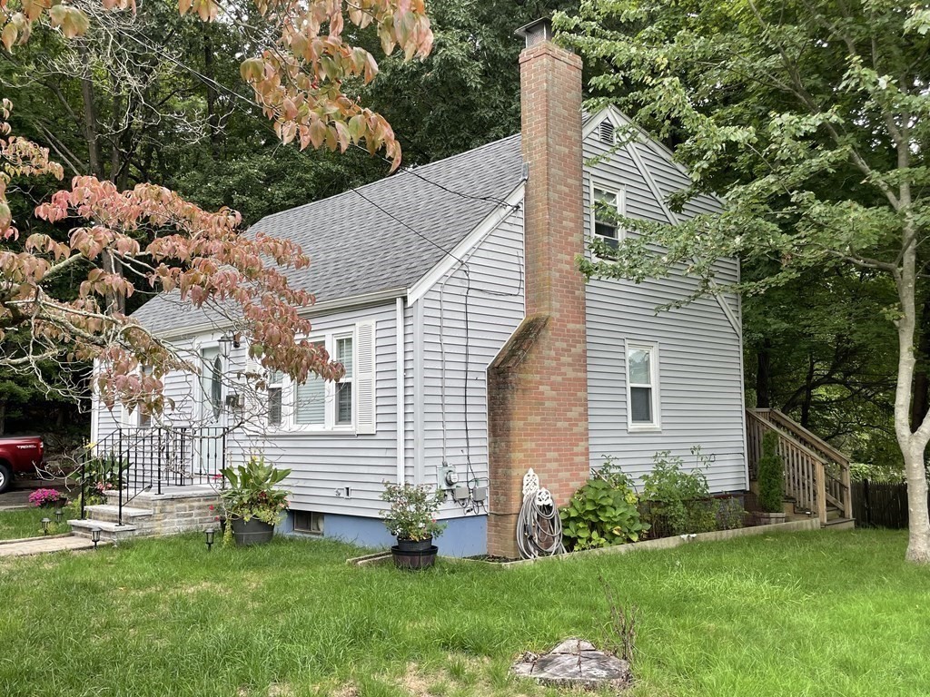 7 Marconi Drive Randolph, MA 02368 - Photo 3 of 24 a front view of a house with a garden and yard