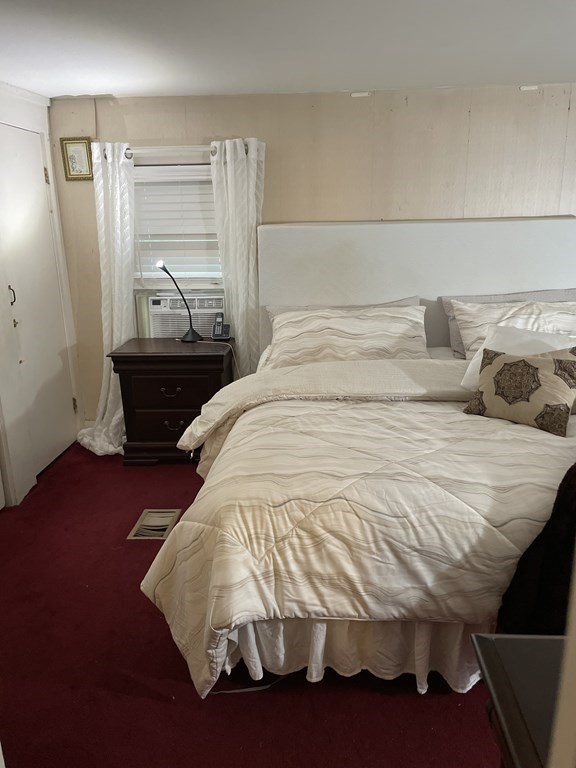 7 Marconi Drive Randolph, MA 02368 - Photo 10 of 24 a bed sitting in a bedroom next to a window