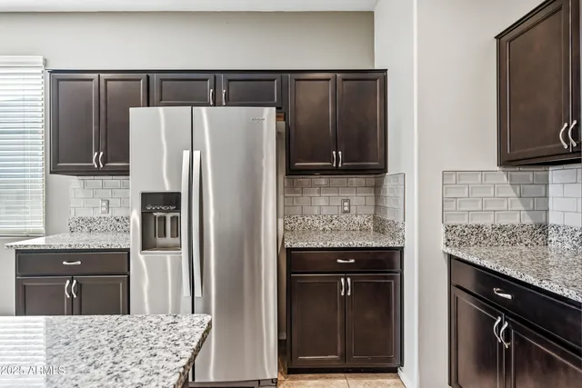 a kitchen with a refrigerator and cabinets