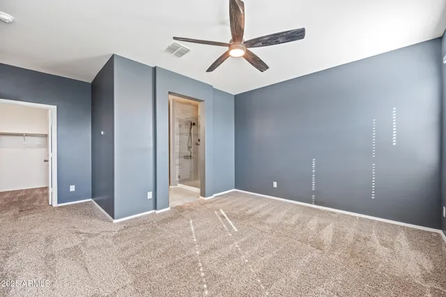 a view of a room with a ceiling fan