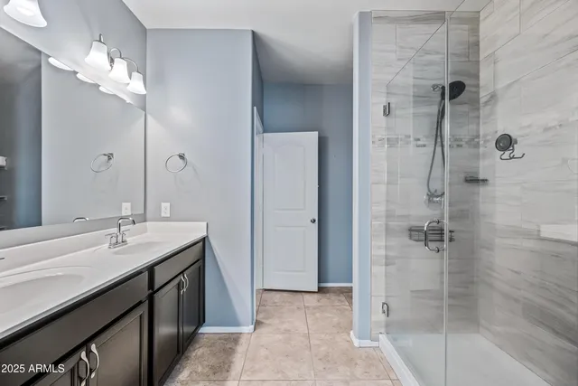 a bathroom with a shower sink and mirror