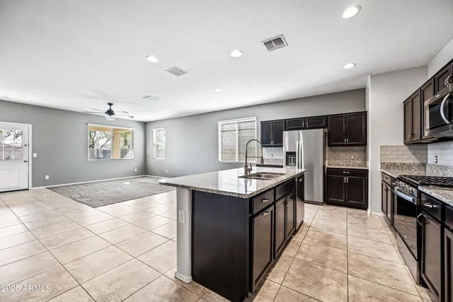 a kitchen with stainless steel appliances granite countertop a sink and a stove