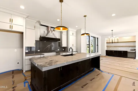 a kitchen with sink stove and refrigerator