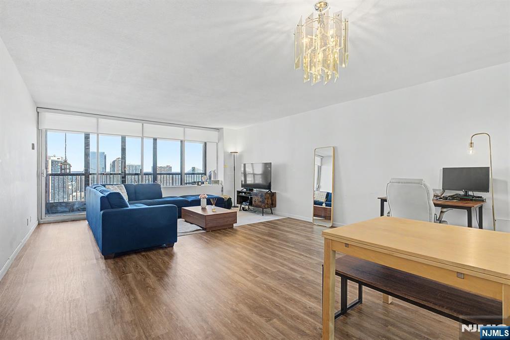 5 Horizon Road, Unit 2506 Fort Lee, NJ 07024 - Photo 2 of 20 a living room with furniture and a table