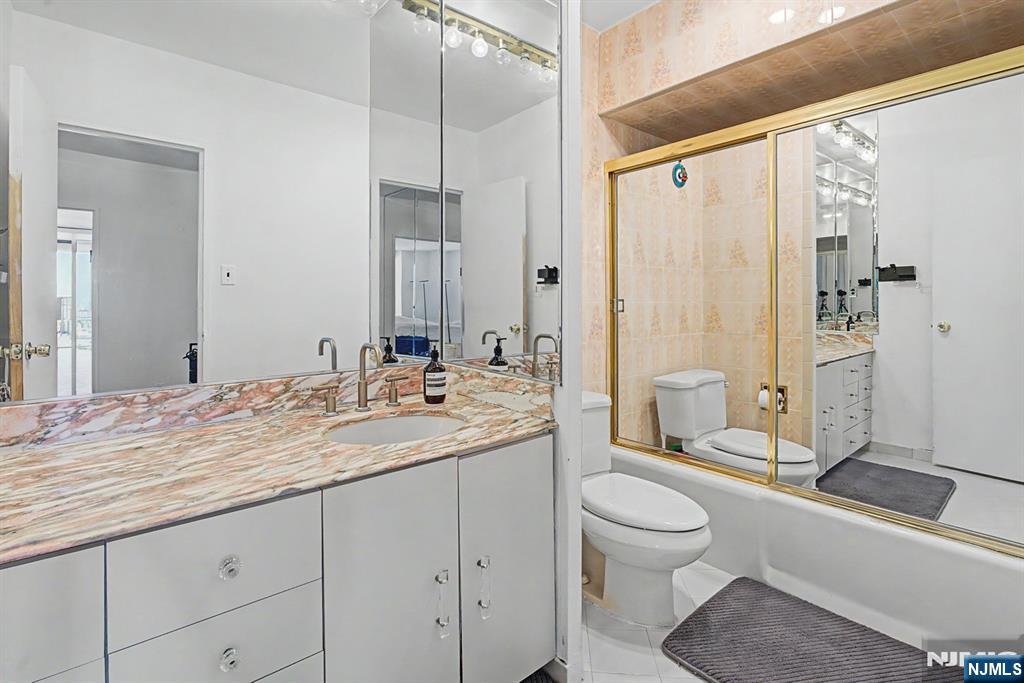 5 Horizon Road, Unit 2506 Fort Lee, NJ 07024 - Photo 9 of 20 a bathroom with a granite countertop sink toilet and shower