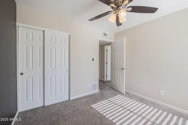 a view of a livingroom with a chandelier fan
