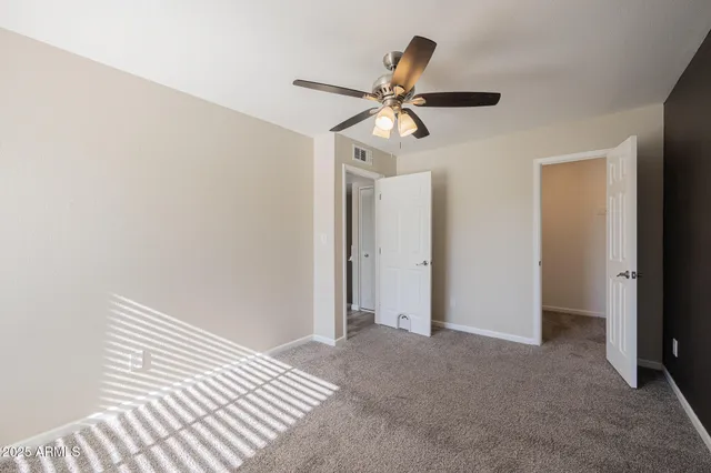 a view of a room with a ceiling fan