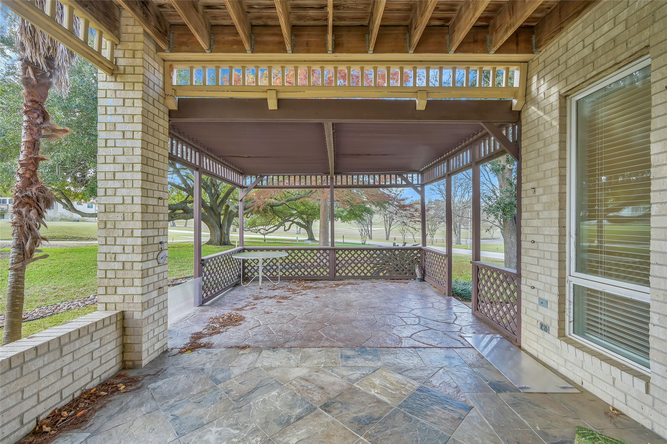 28 Waters Edge Street Conroe, TX 77356 - Photo 19 of 20 a view of a porch with a floor to ceiling window and wooden fence