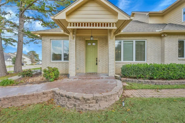a view of a house with brick walls