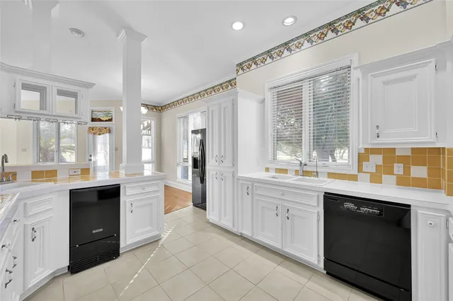 a large kitchen with stainless steel appliances kitchen island granite countertop a sink and cabinets