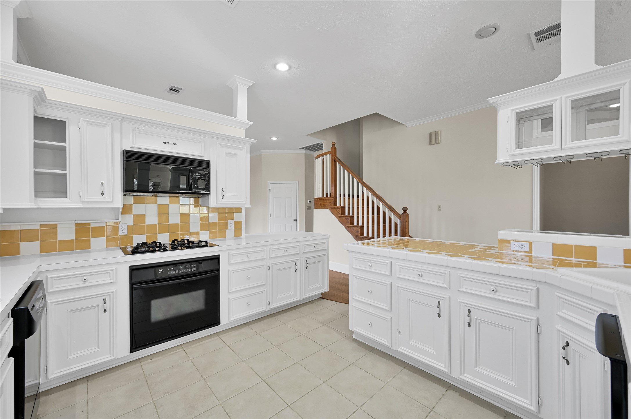 28 Waters Edge Street Conroe, TX 77356 - Photo 4 of 20 a kitchen with granite countertop white cabinets and stainless steel appliances