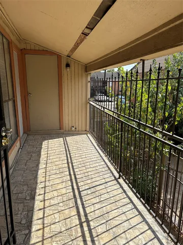 a view of balcony with wooden floor