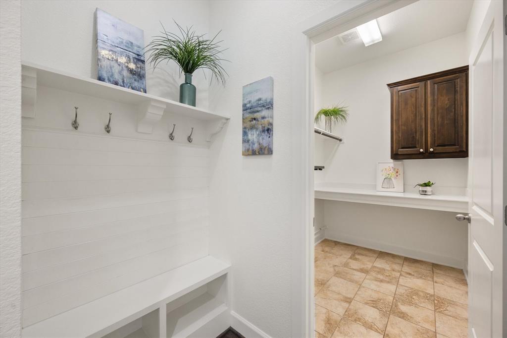 1201 9th Street Argyle, TX 76226 - Photo 17 of 40 a bathroom with a bathtub sink and mirror