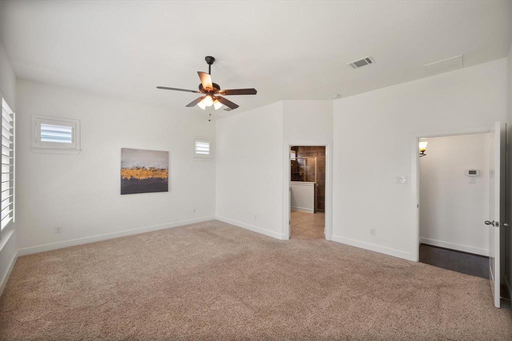 1201 9th Street Argyle, TX 76226 - Photo 19 of 40 an empty room with windows and fan