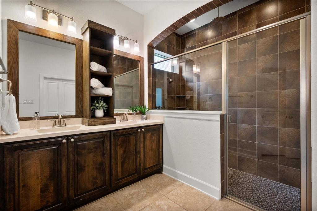 1201 9th Street Argyle, TX 76226 - Photo 20 of 40 a bathroom with a double vanity sink a toilet and a mirror