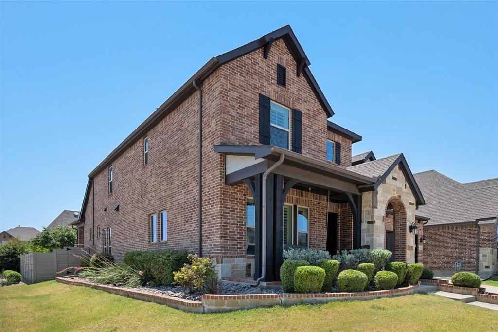 1201 9th Street Argyle, TX 76226 - Photo 2 of 40 a view of a brick house with large windows