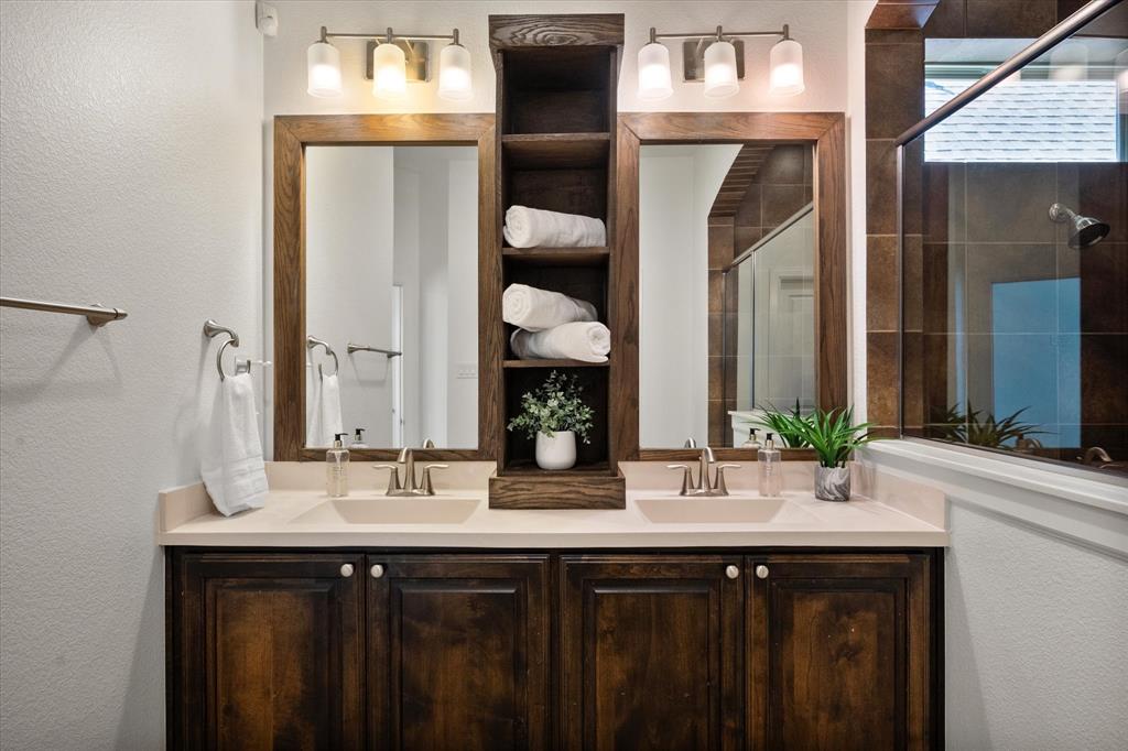 1201 9th Street Argyle, TX 76226 - Photo 21 of 40 a bathroom with a double vanity sink and a mirror