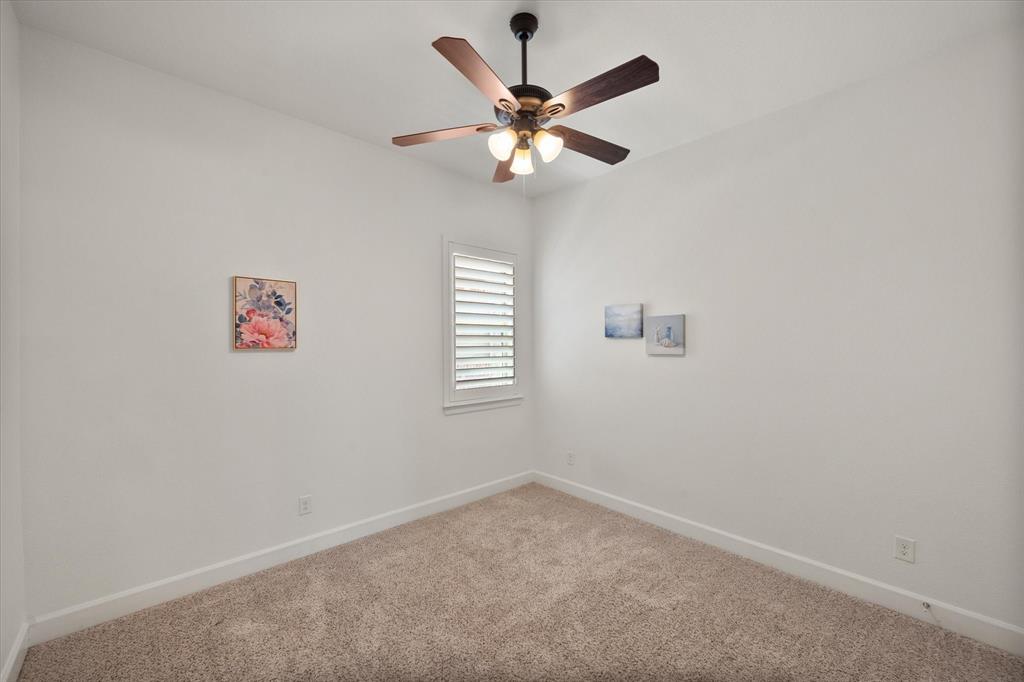 1201 9th Street Argyle, TX 76226 - Photo 22 of 40 an empty room with a window and a fan
