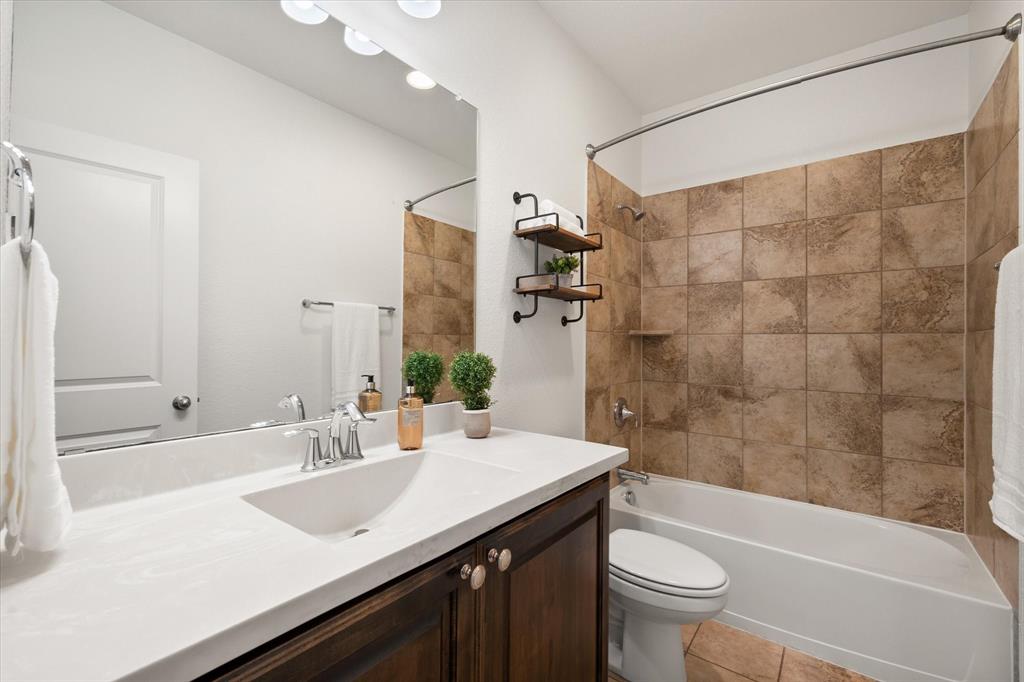 1201 9th Street Argyle, TX 76226 - Photo 26 of 40 a bathroom with a sink a toilet and shower