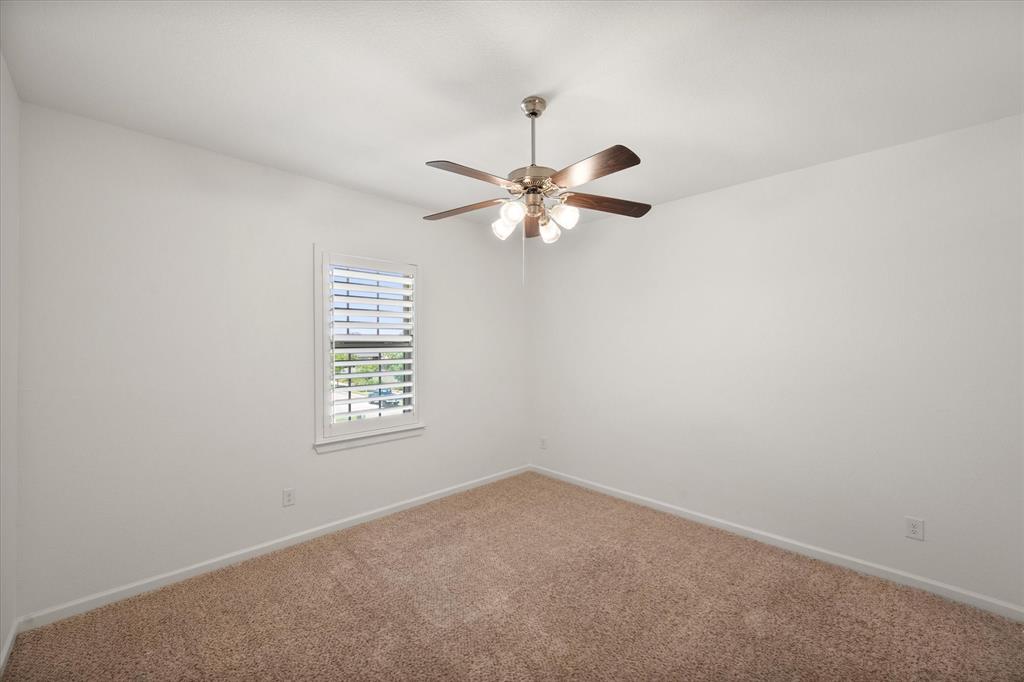 1201 9th Street Argyle, TX 76226 - Photo 29 of 40 an empty room with a window and a fan