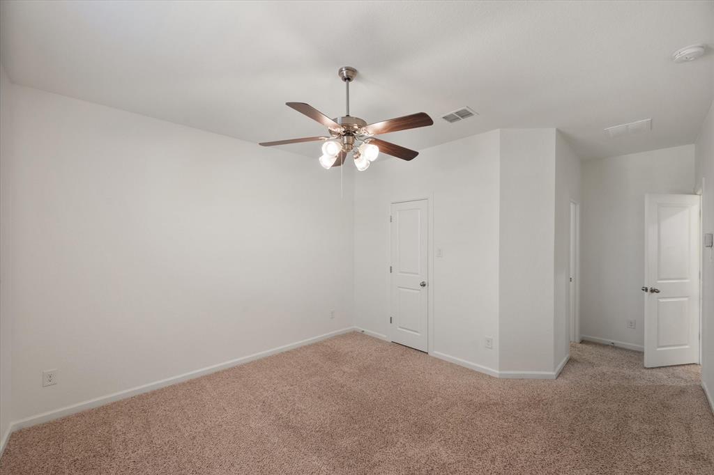 1201 9th Street Argyle, TX 76226 - Photo 30 of 40 an empty room with a window and a ceiling fan