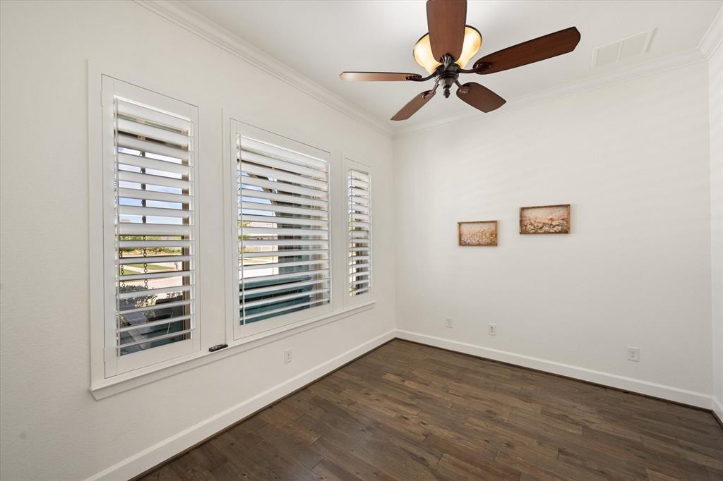 1201 9th Street Argyle, TX 76226 - Photo 5 of 40 an empty room with wooden floor fan and windows