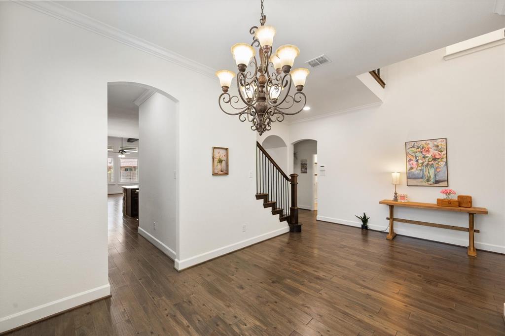 1201 9th Street Argyle, TX 76226 - Photo 6 of 40 a view of a livingroom with wooden floor and a chandelier