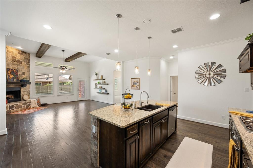 1201 9th Street Argyle, TX 76226 - Photo 8 of 40 a kitchen with a sink stove and wooden floor