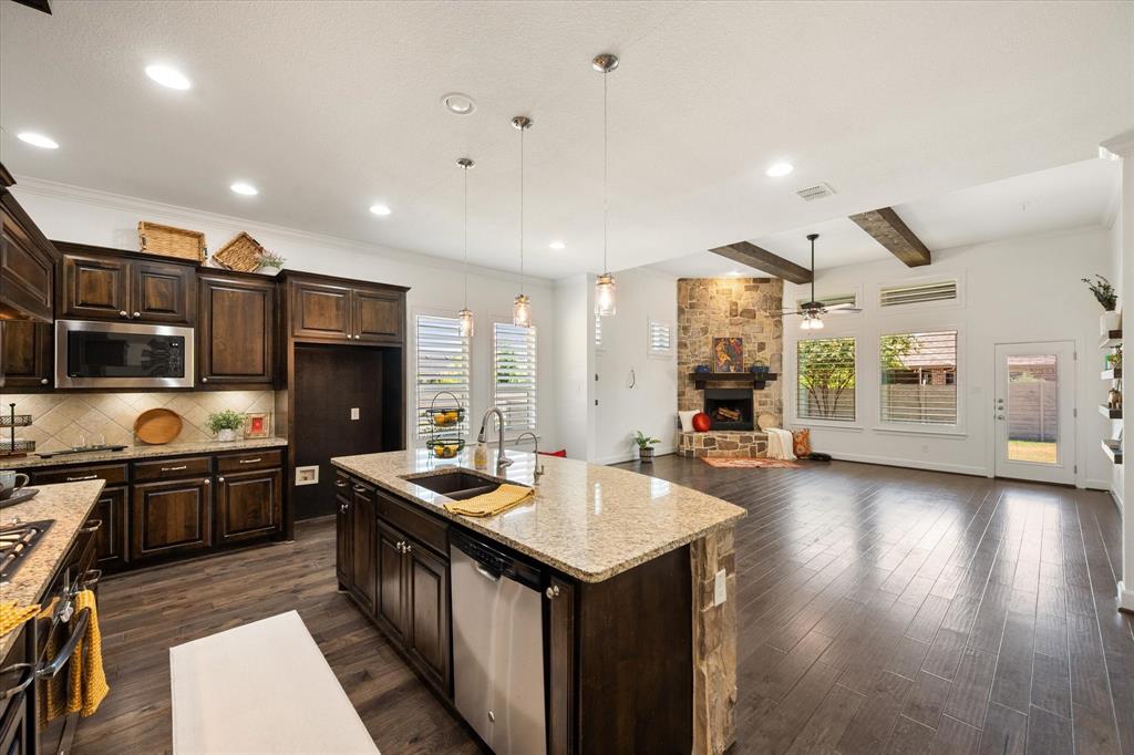 1201 9th Street Argyle, TX 76226 - Photo 10 of 40 a kitchen with stainless steel appliances granite countertop lots of counter top space