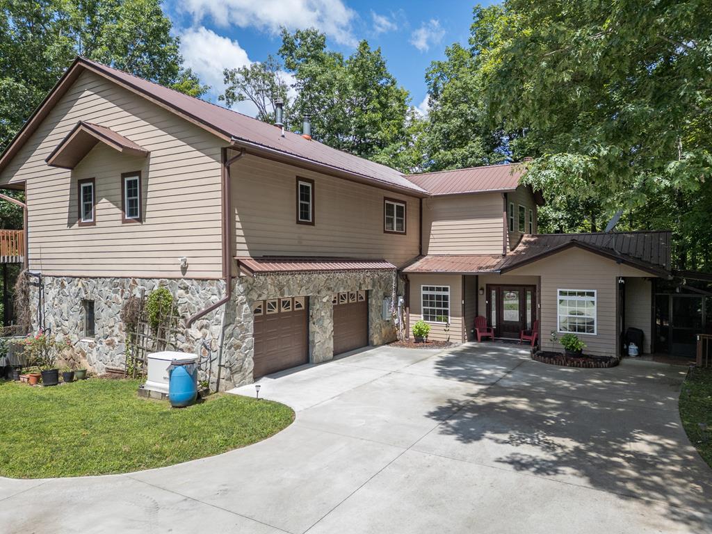 a view of a house with a yard and potted plants