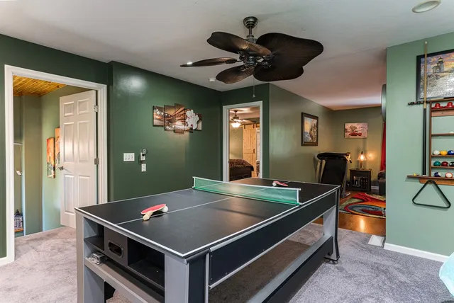 a bathroom with a granite countertop sink a mirror a bathtub and shower