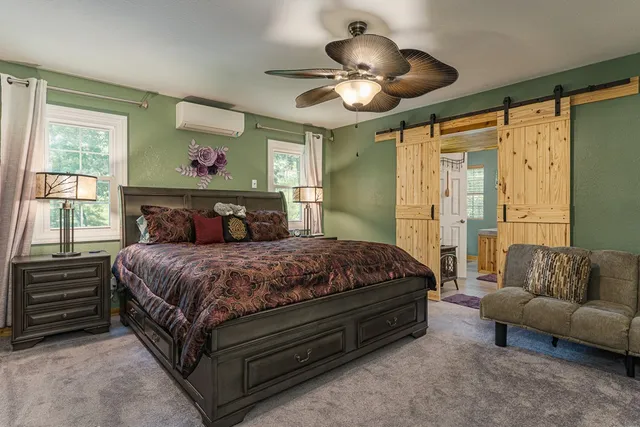 a spacious bathroom with a tub a sink and glass door shower